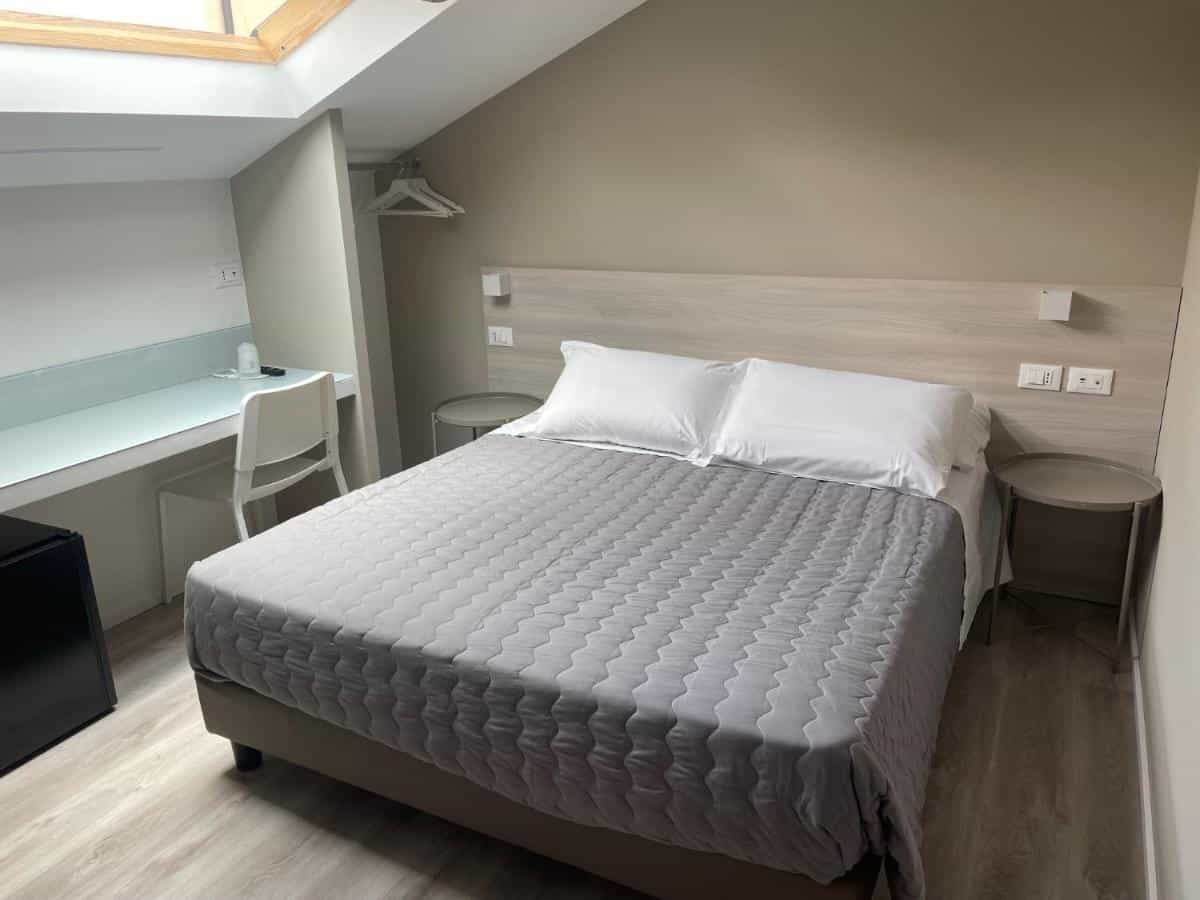 Hotel Principe room with double bed, skylight, and built-in desk area