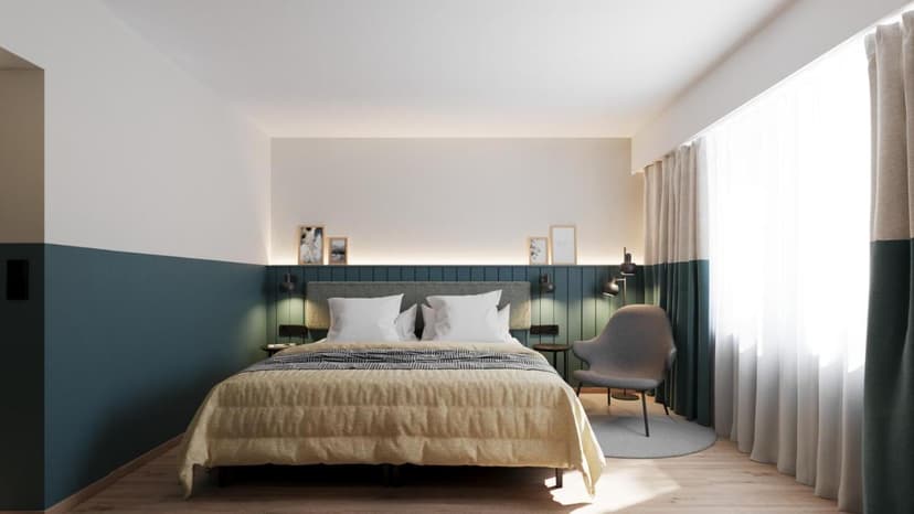 Hotel room with queen bed, blue accent wall, and bright window with sheer curtains at City Hotel Biel-Bienne.