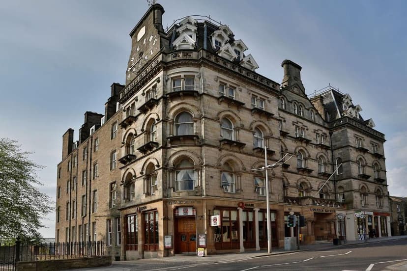 Best Western Queens Hotel building with stone facade and ornate roof in city setting.