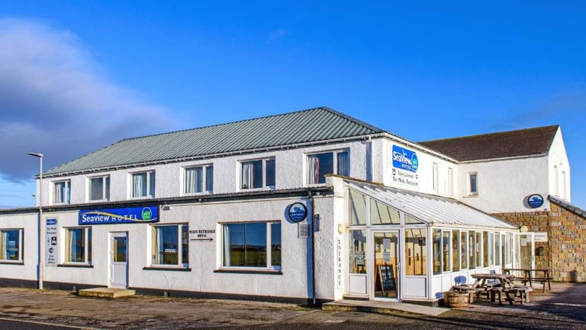 Seaview Hotel building with white textured walls and conservatory entrance, John O'Groats