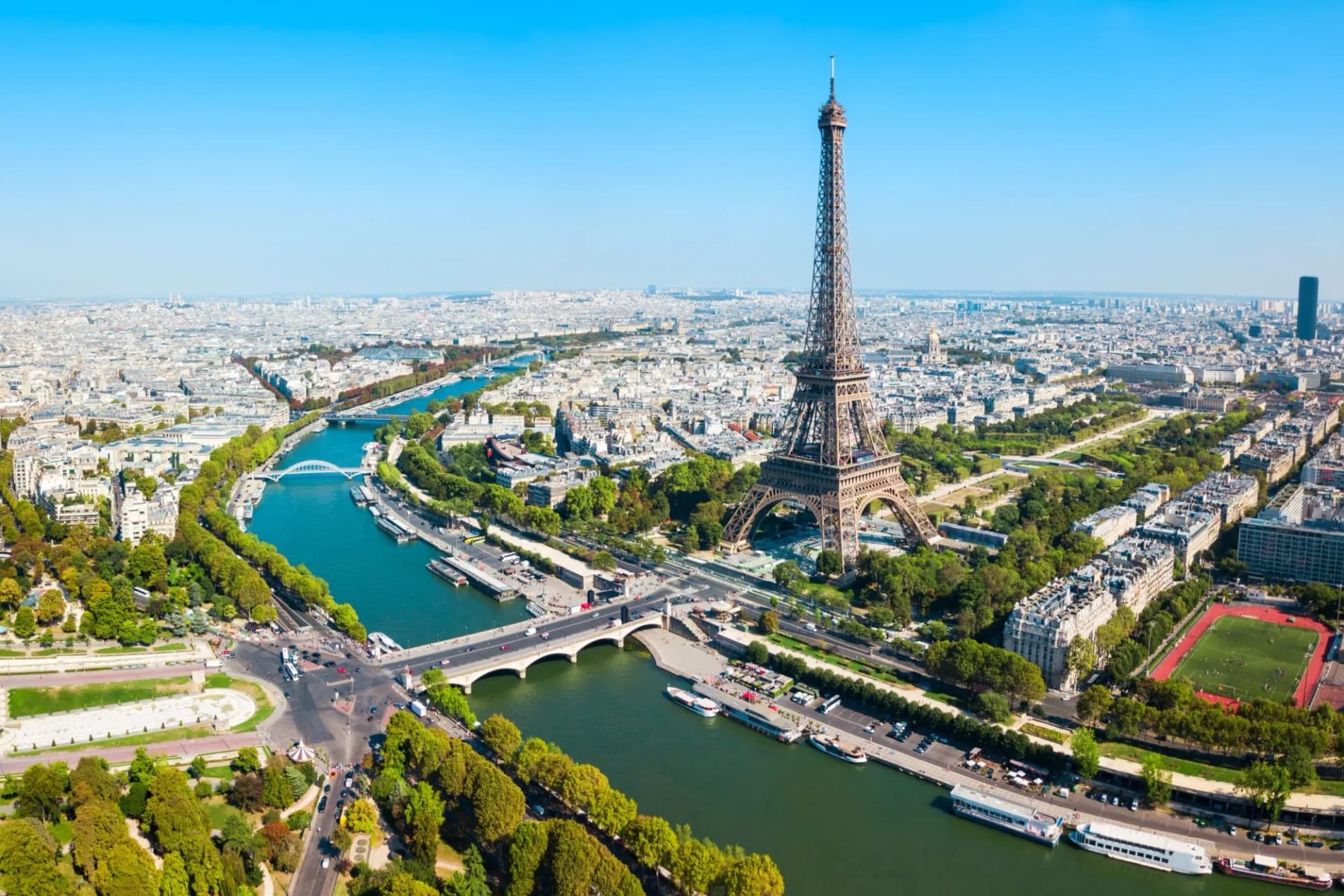 Aerial view of the Eiffel Tower overlooking the Seine River and the cityscape of Paris.