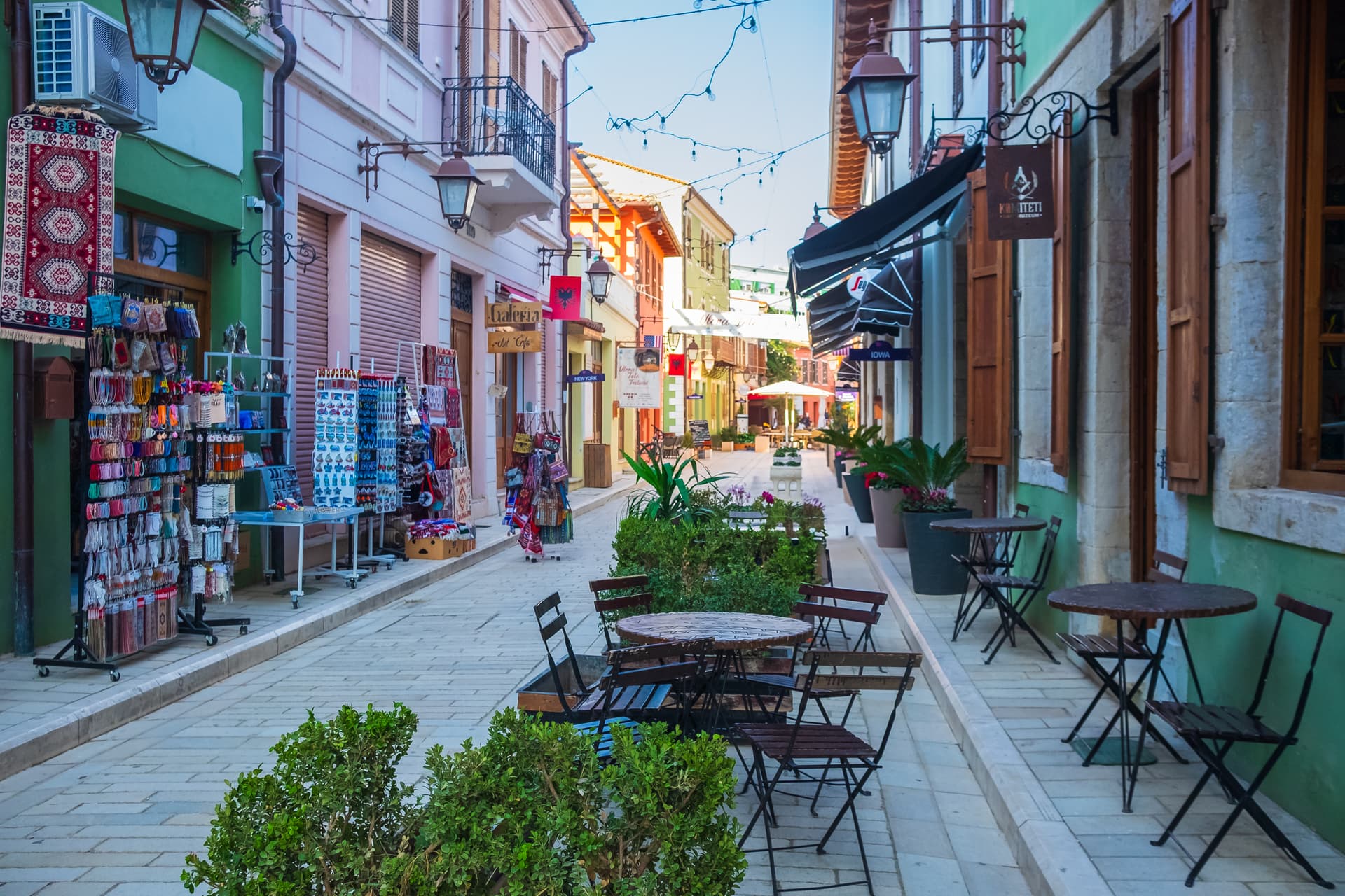 Shops and outdoor cafe seating on a pedestrian street in Vlore Old Town, Albania.