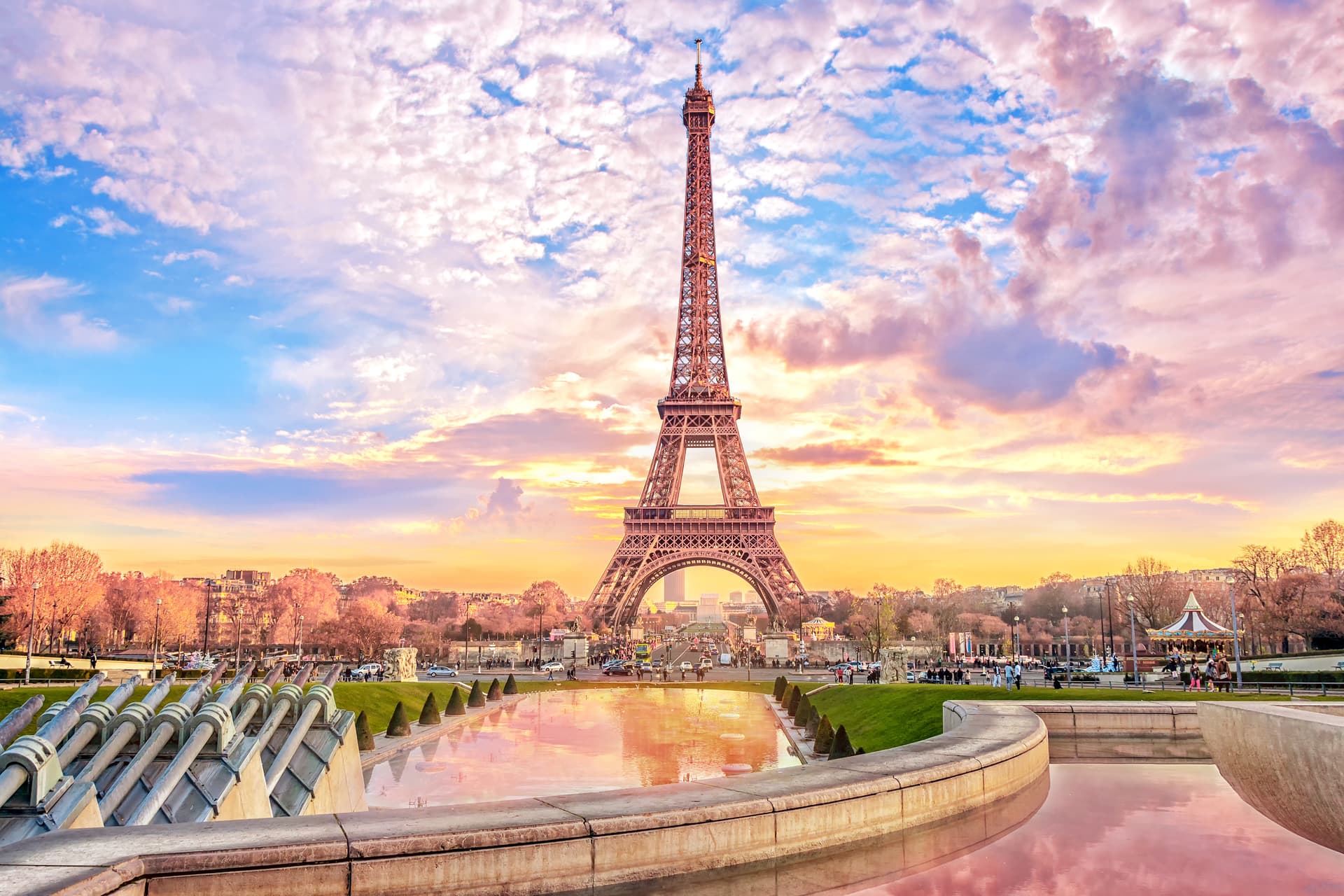 Eiffel Tower reflected in pool at sunset with pink and blue clouds in Paris
