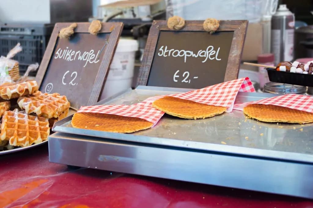 Waffles for sale at a market stall, including stroopwafels and suikerwafels.