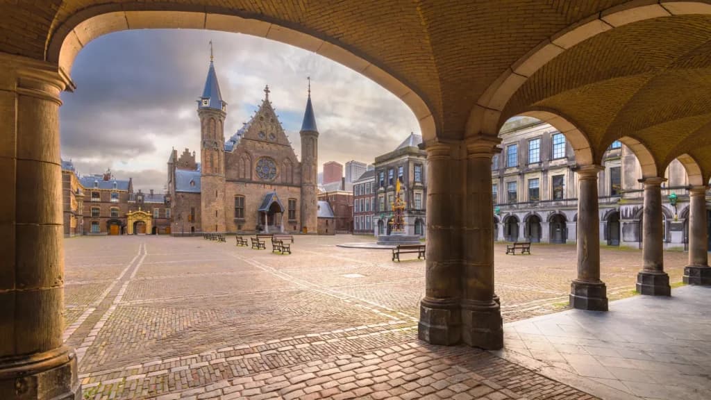 Binnenhof courtyard with historic buildings framed by stone arches in The Hague