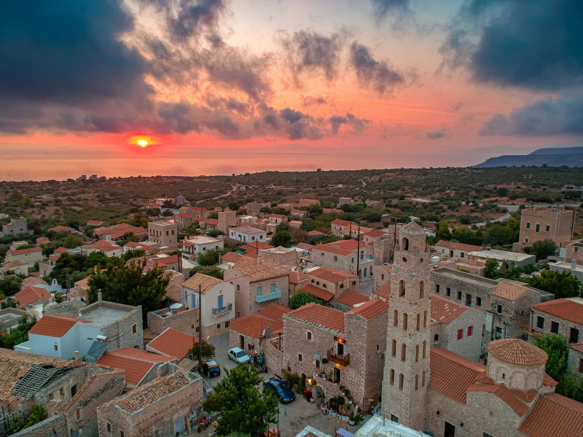 Iconic scenery over the old historical town of Areopoli Lakonia, Greece against a dramatic sunset sky