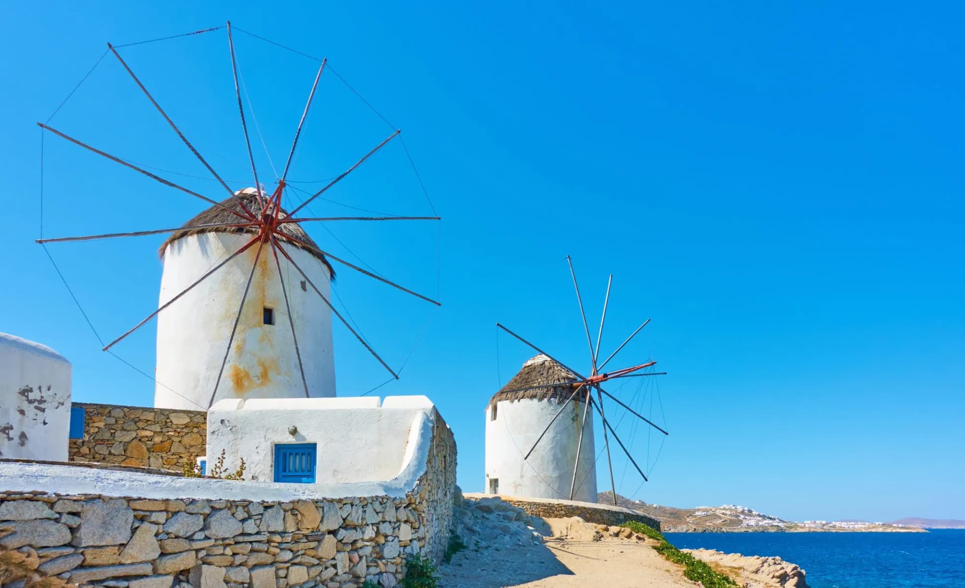 Old white windmillls by the sea in Mykonos