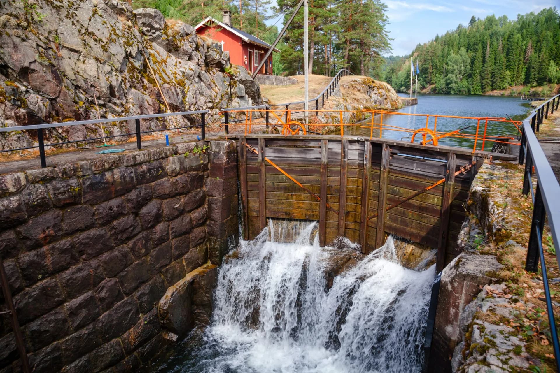 Water rushing from wooden lock gates at Eidsfoss Lock on the Telemark Canal, Norway.
