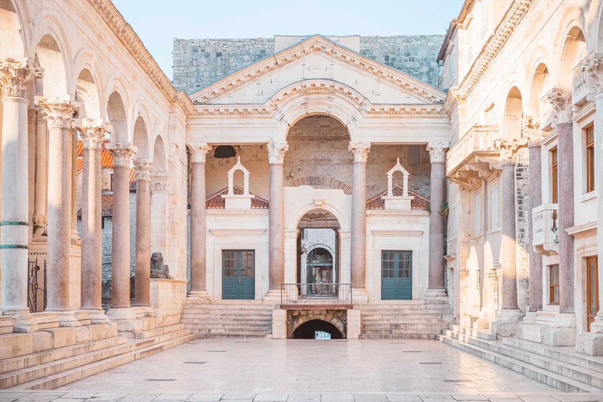 Diocletian's Palace courtyard with Romanesque arches, columns, and stone steps in Split.