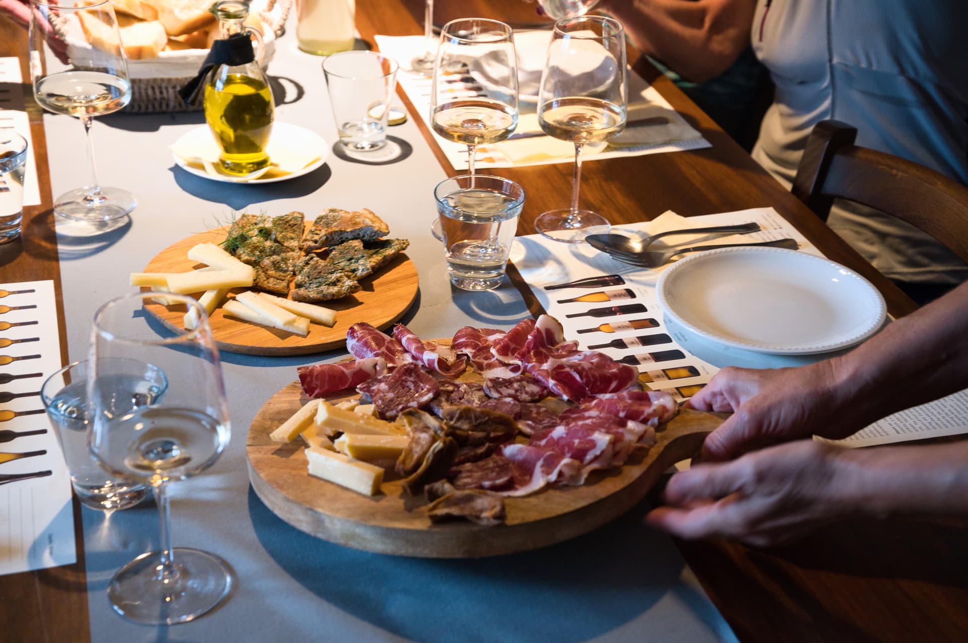 Wine tasting with charcuterie and cheese boards during a cycling tour in Slovenia.