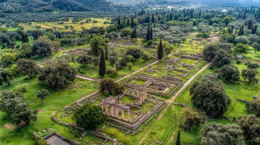 Ancient ruins of Sparta at dawn in Greece aerial view with green grass and scattered trees