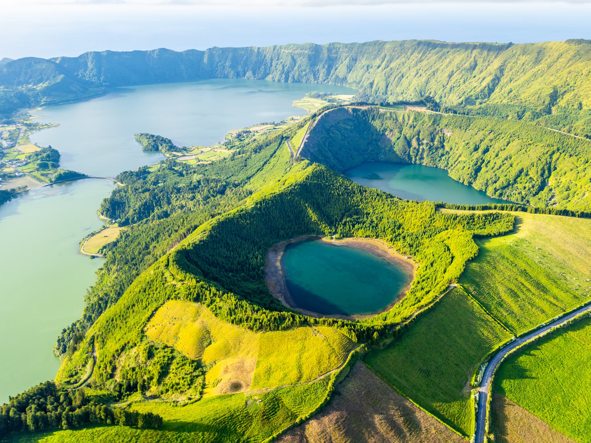 Aerial view of Sete Cidades caldera lakes and lush green volcanic crater landscape.