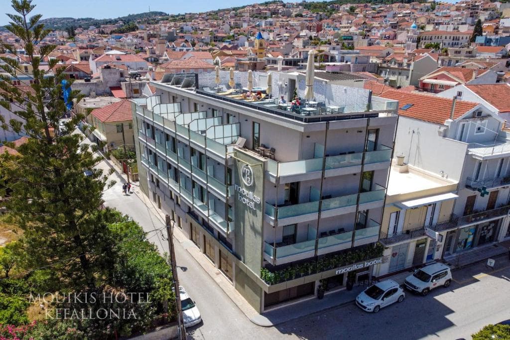 Mouikis Hotel with rooftop terrace and surrounding town buildings in Kefallonia.