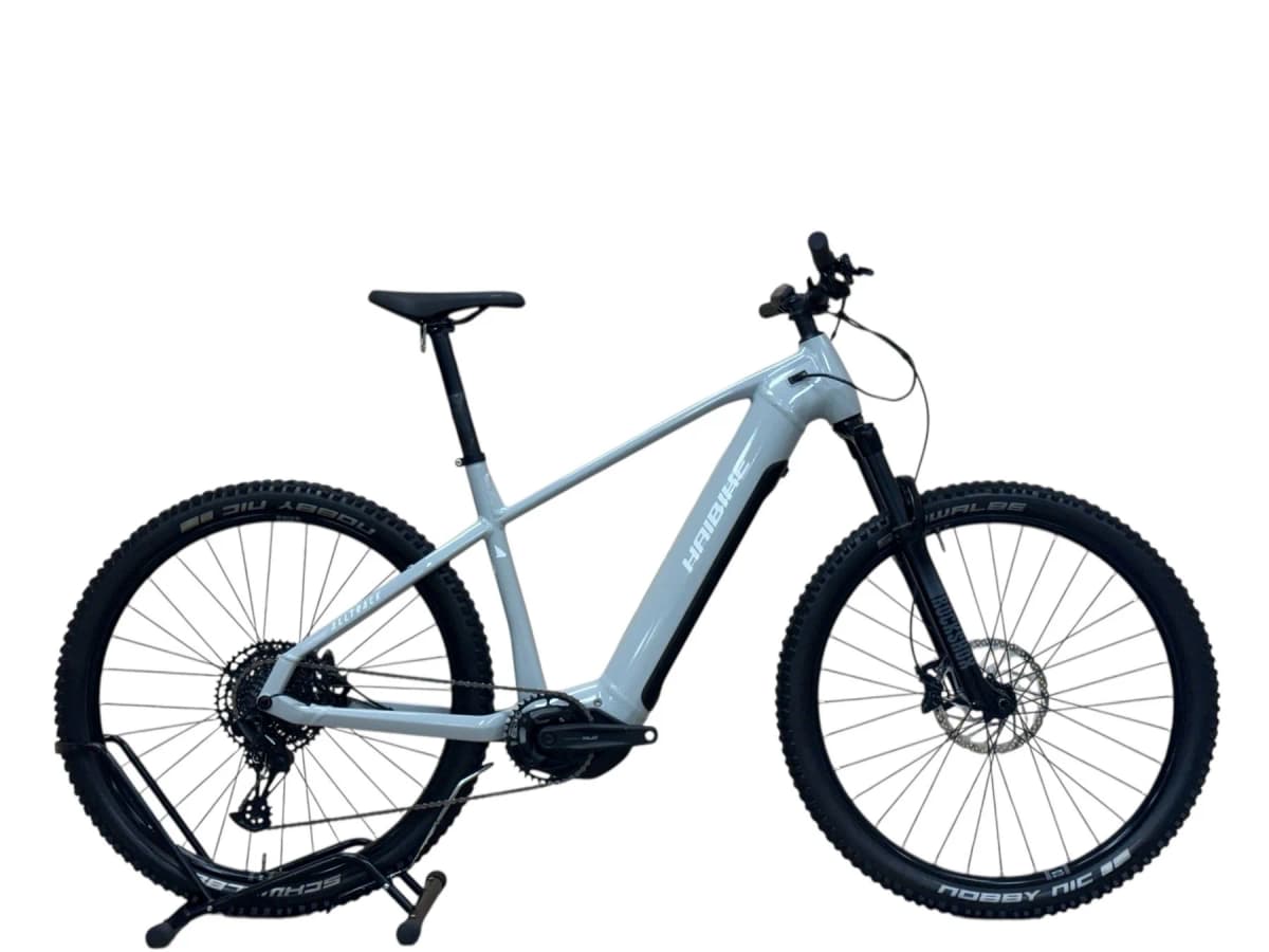 Light grey Haibike Alltrack electric mountain bike on a stand.