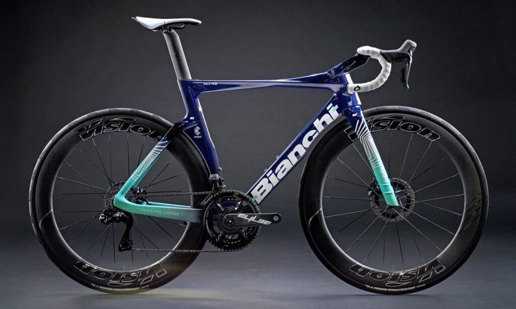 Bianchi Oltre RC road bike with blue and teal frame against a dark studio background.