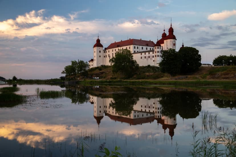 Evening shot of Lacko castle with reflection in the mirror like water of lake Vanern, Lidköping, Sweden