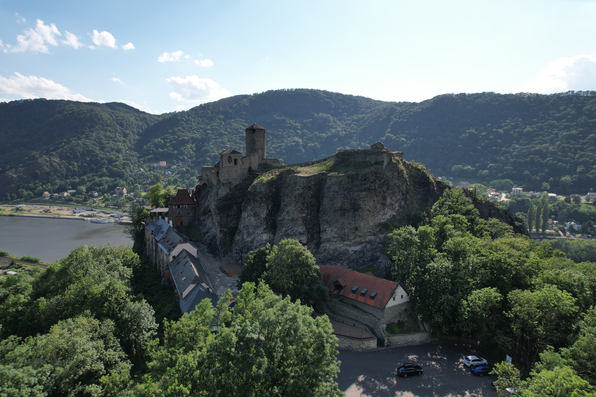 Stone castle ruins atop a rocky cliff overlooking the Elbe River in Usti nad Labem.