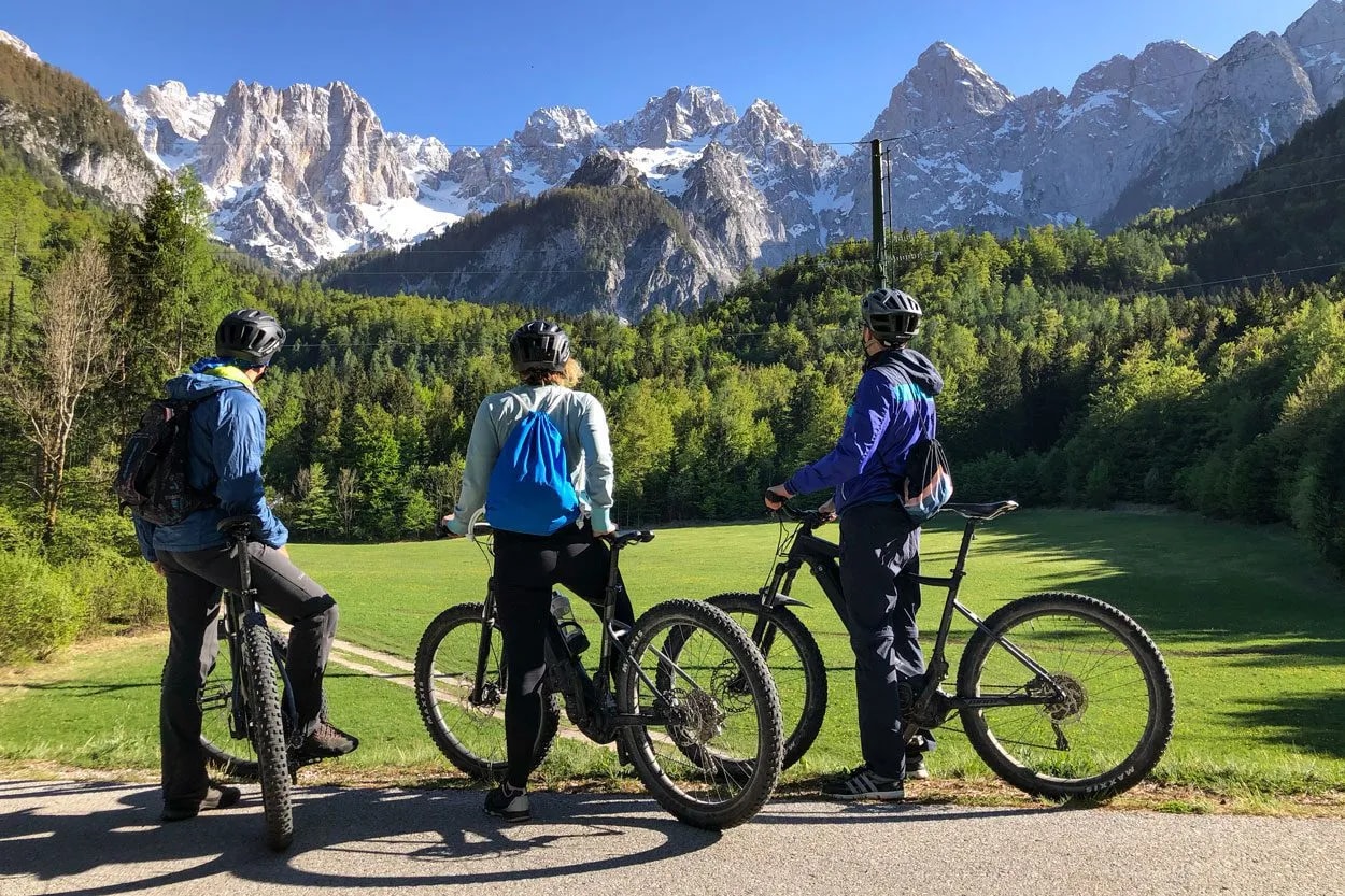 Mountain biking with Julian Alps view from Upper Sava valley, sunny day.