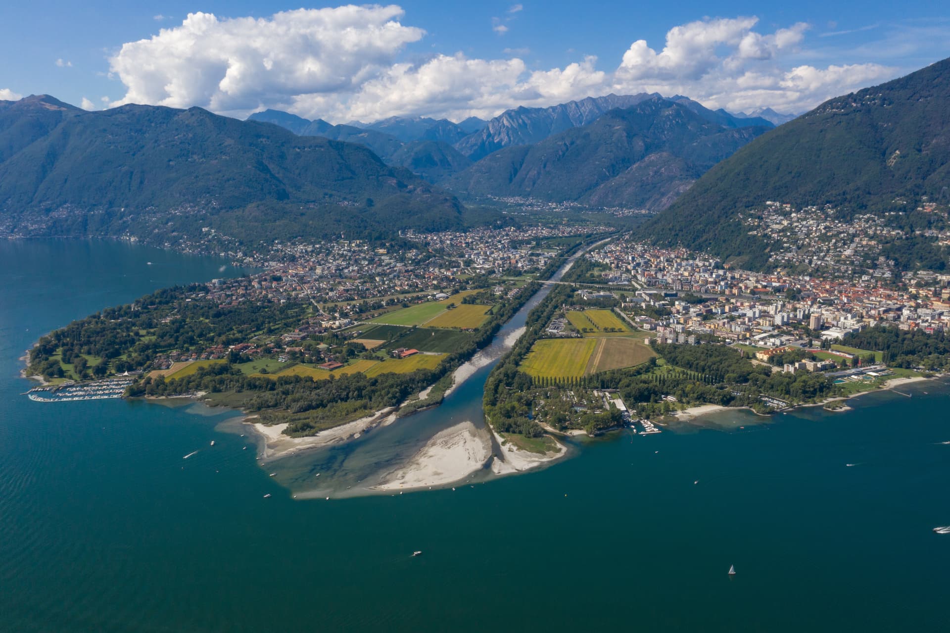 Aerial view of Locarno and Ascona on Lake Maggiore with mountains and river delta.