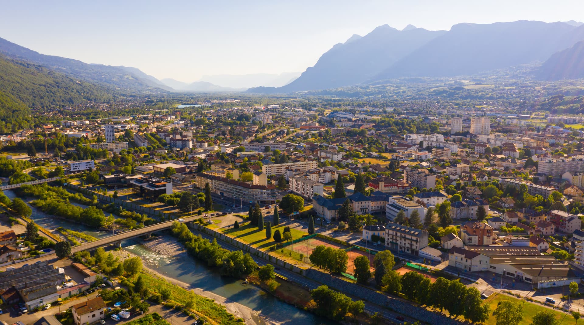 Scenic aerial view of Albertville town in green alpine valley on Arly River.