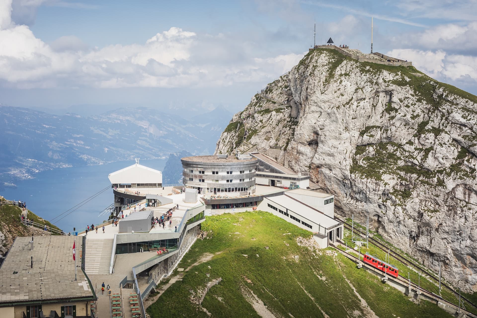 Cogwheel train arriving at Mount Pilatus station overlooking Lucerne lake, Switzerland.