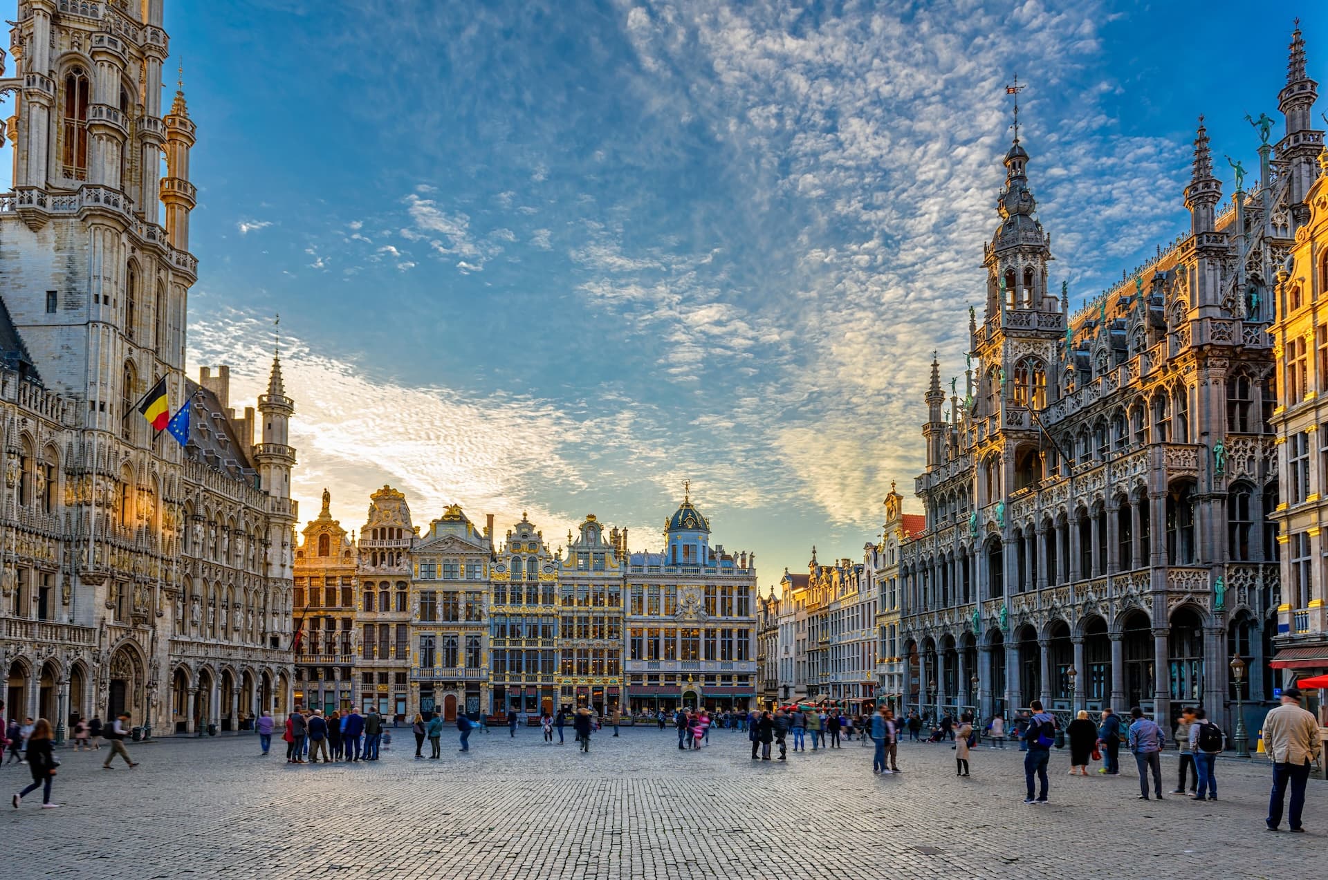 Grand Place square with ornate guildhalls and Town Hall under a dramatic sky in Brussels