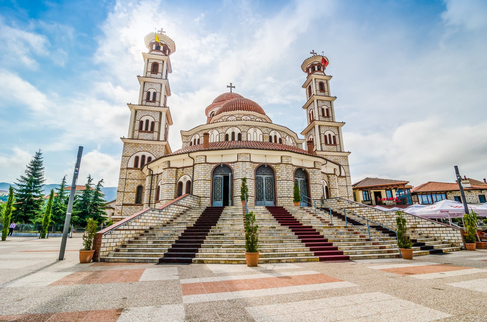 Orthodox Cathedral of the Resurrection of Christ in Korce, Albania, with stone facade and twin bell towers.