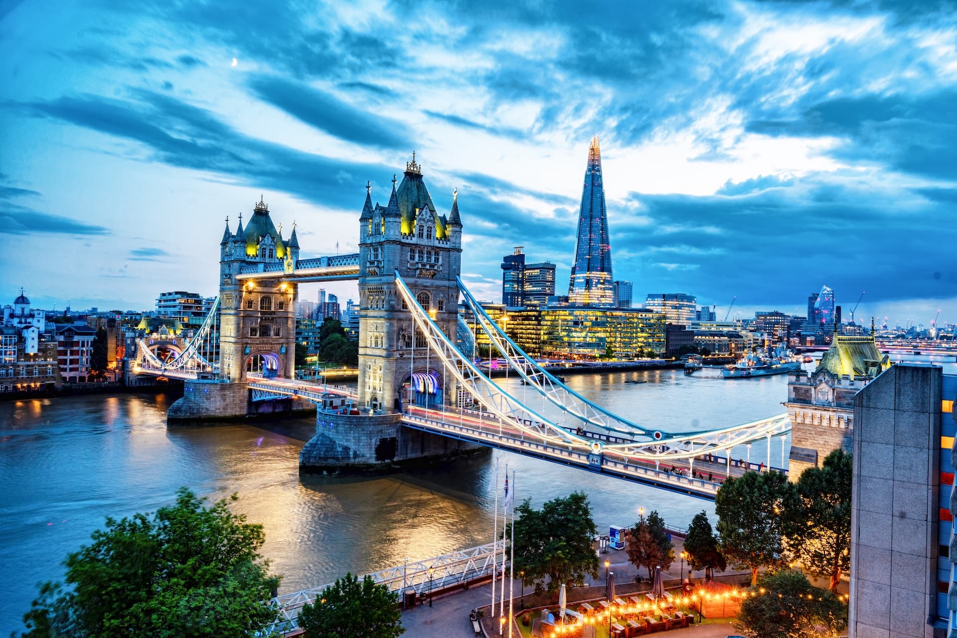 Tower Bridge illuminated at dusk over the River Thames with The Shard in London skyline