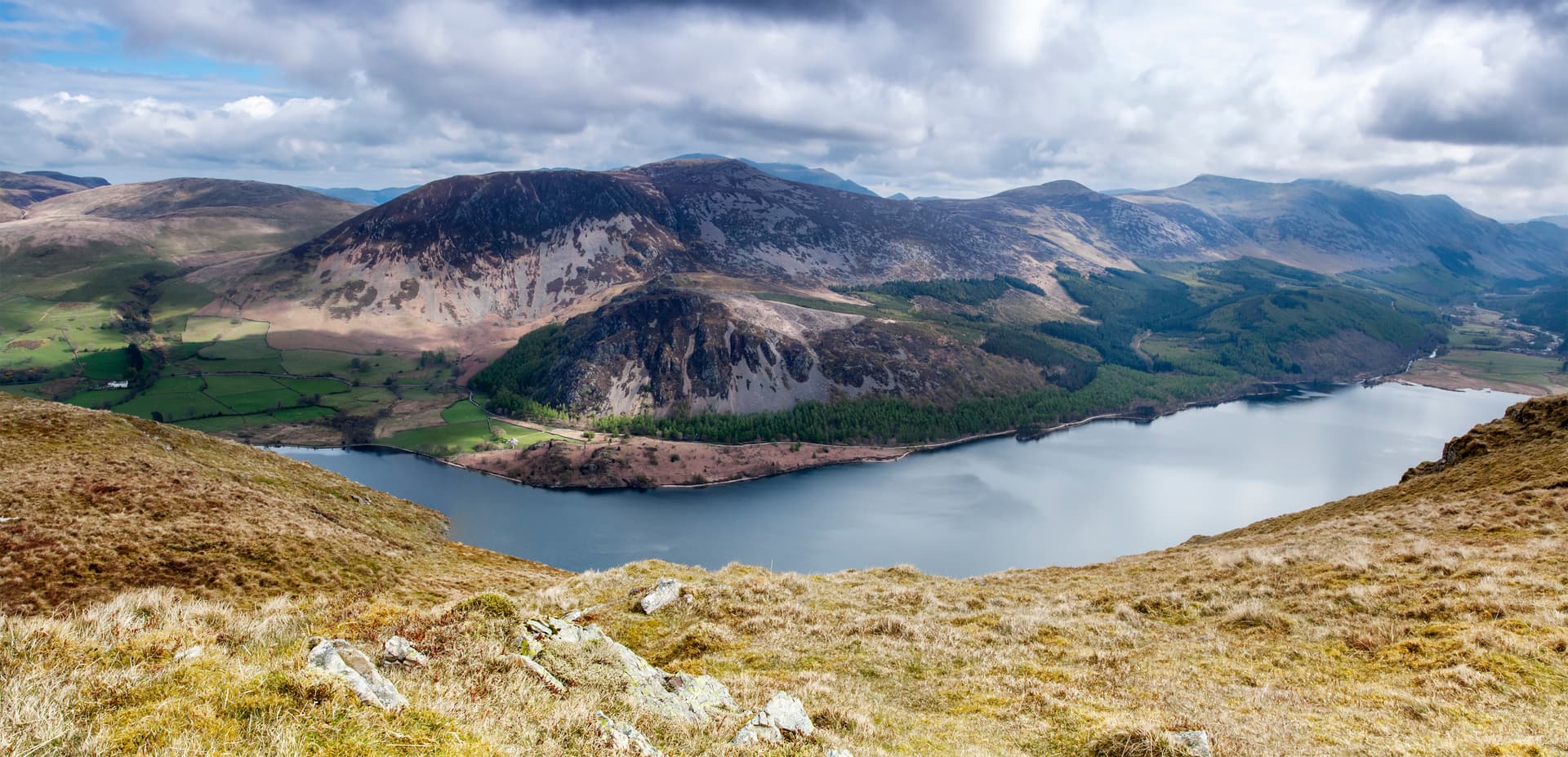 View over Ennerdale Valley lake with rugged mountains and cloudy sky in the Lake District