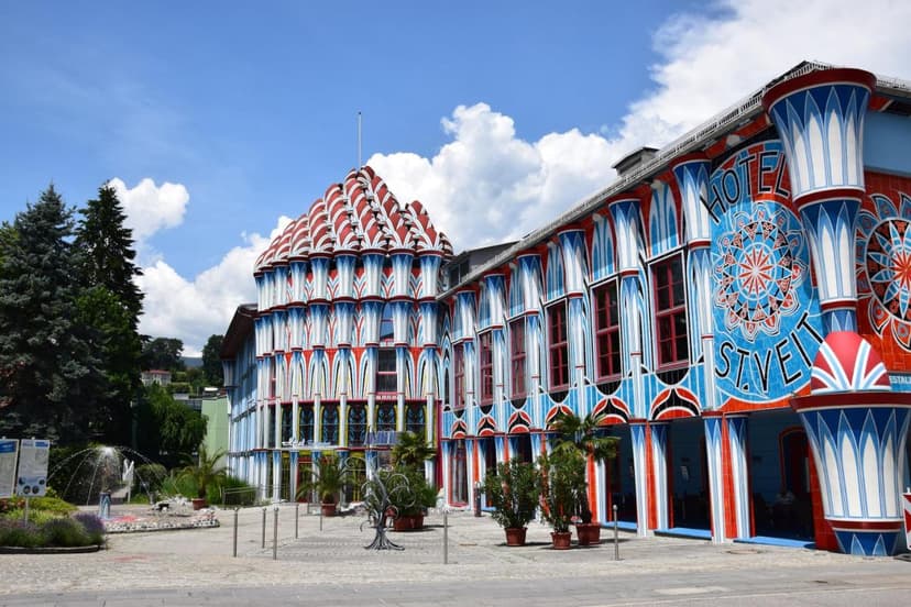 Hotel Fuchspalast with colorful Hundertwasser-inspired facade and fountain in St. Veit.