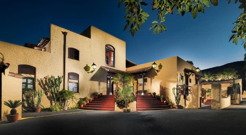 Rural hotel Finca Salamanca entrance at dusk with cacti and illuminated facade