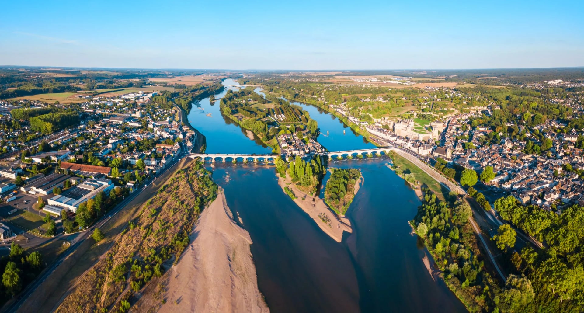 Aerial panoramic view of Château d'Amboise overlooking the Loire River and bridge in France.