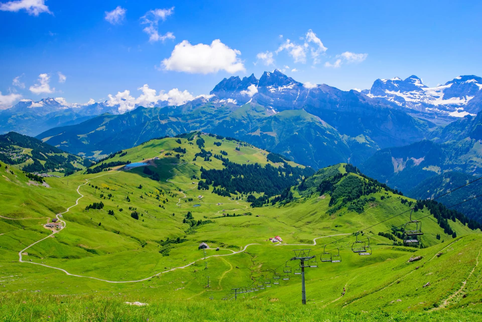 Summer landscape in Portes du Soleil, Switzerland, with green mountains and a gondola lift.