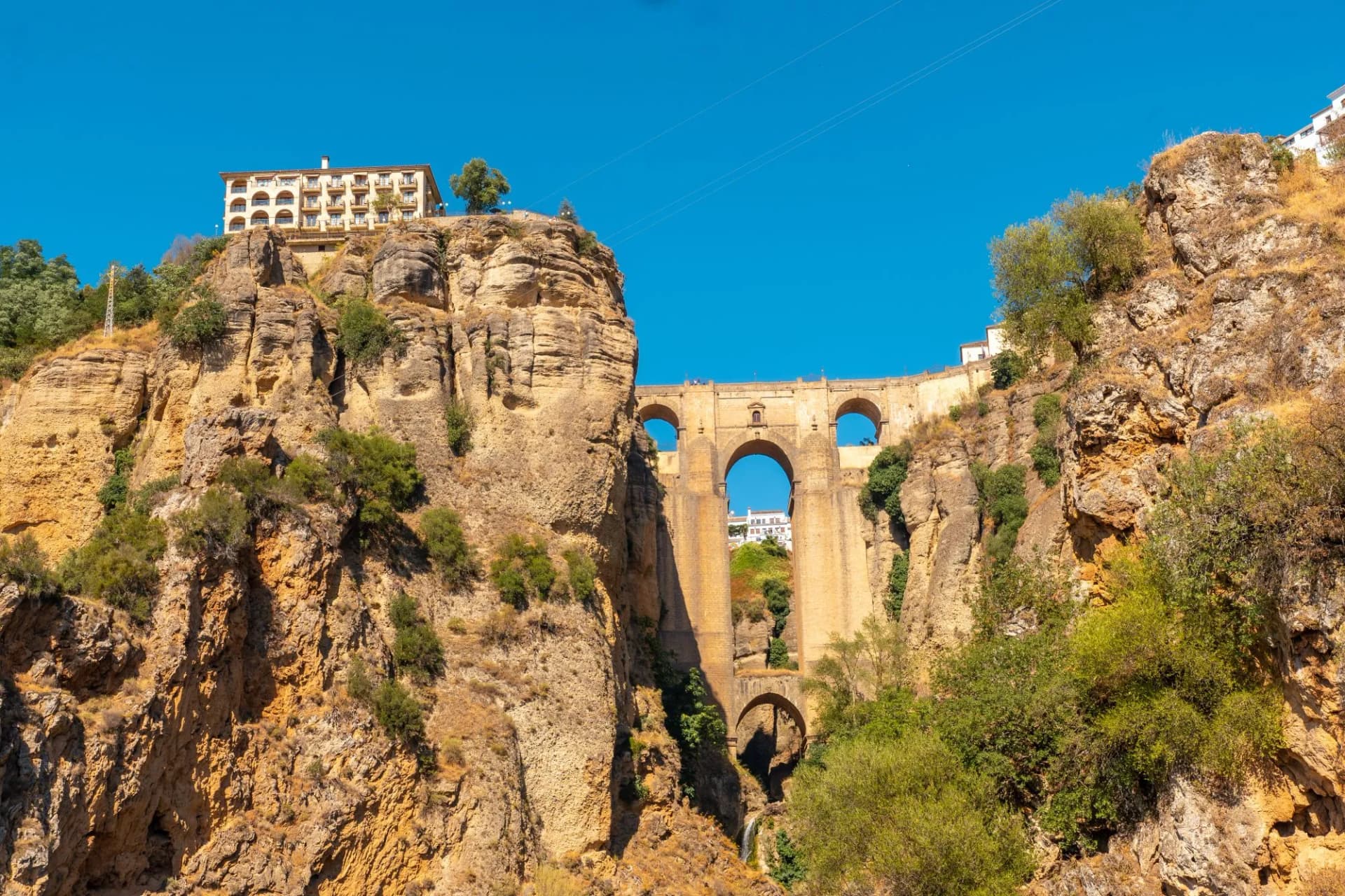 Puente Nuevo bridge spanning a deep gorge with buildings atop cliffs in Ronda, Malaga, Andalucia.