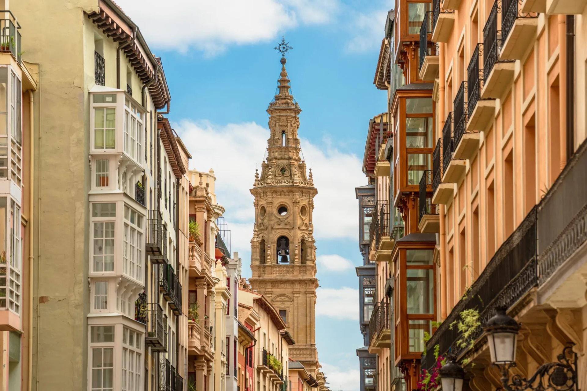 Bell tower of Logroño Cathedral visible between colorful historic buildings in La Rioja, Spain.