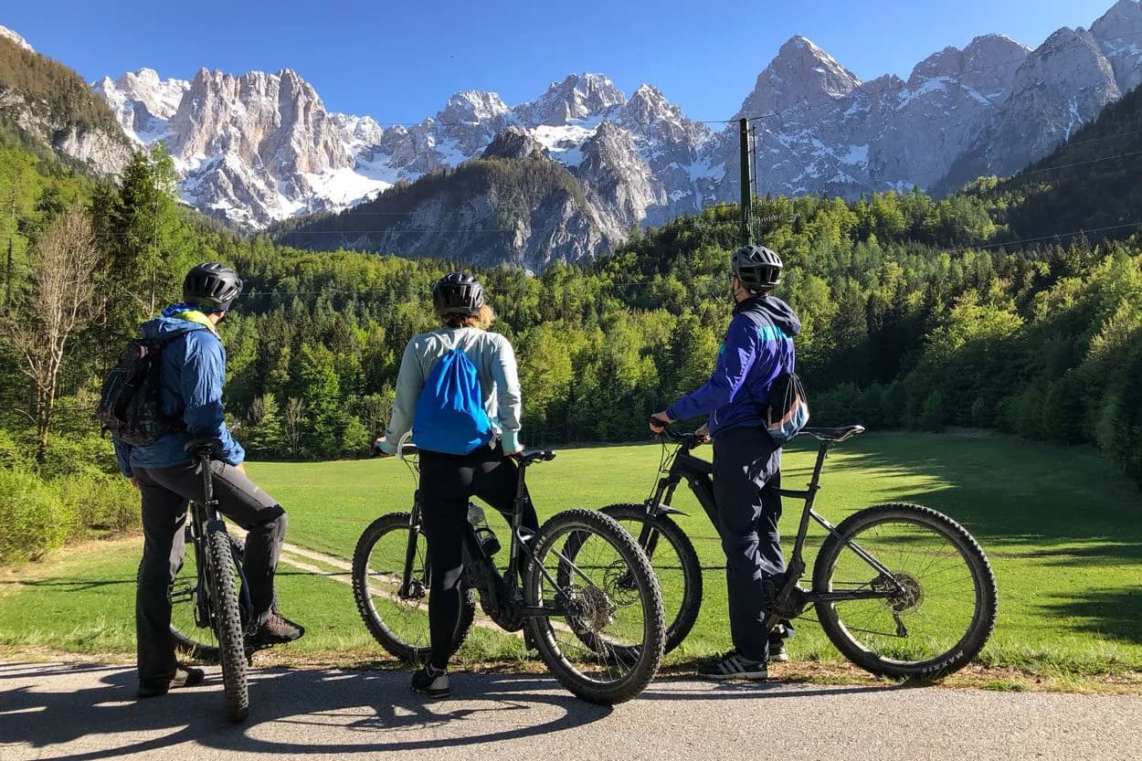 Mountain biking with Julian Alps view from Upper Sava valley, sunny day.