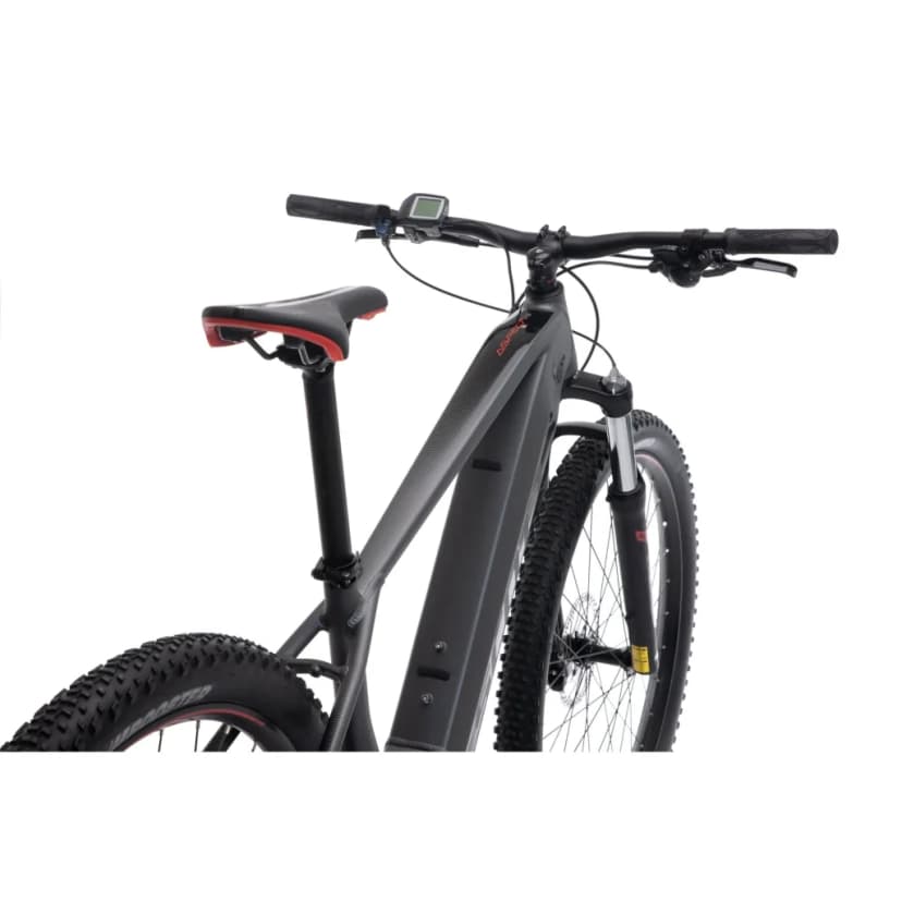 Close-up of black electric mountain bike frame, seat, handlebars, and knobby tires against white background