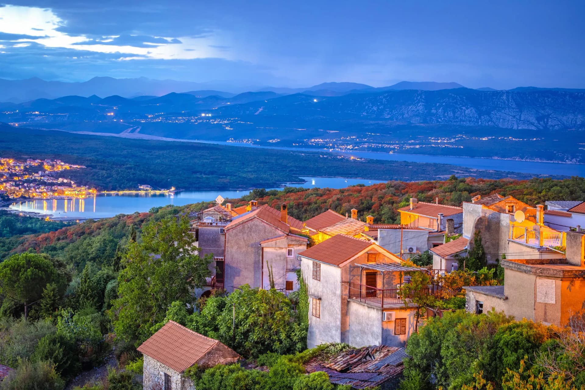Historic town of Dobrinj and turquoise Soline bay evening view