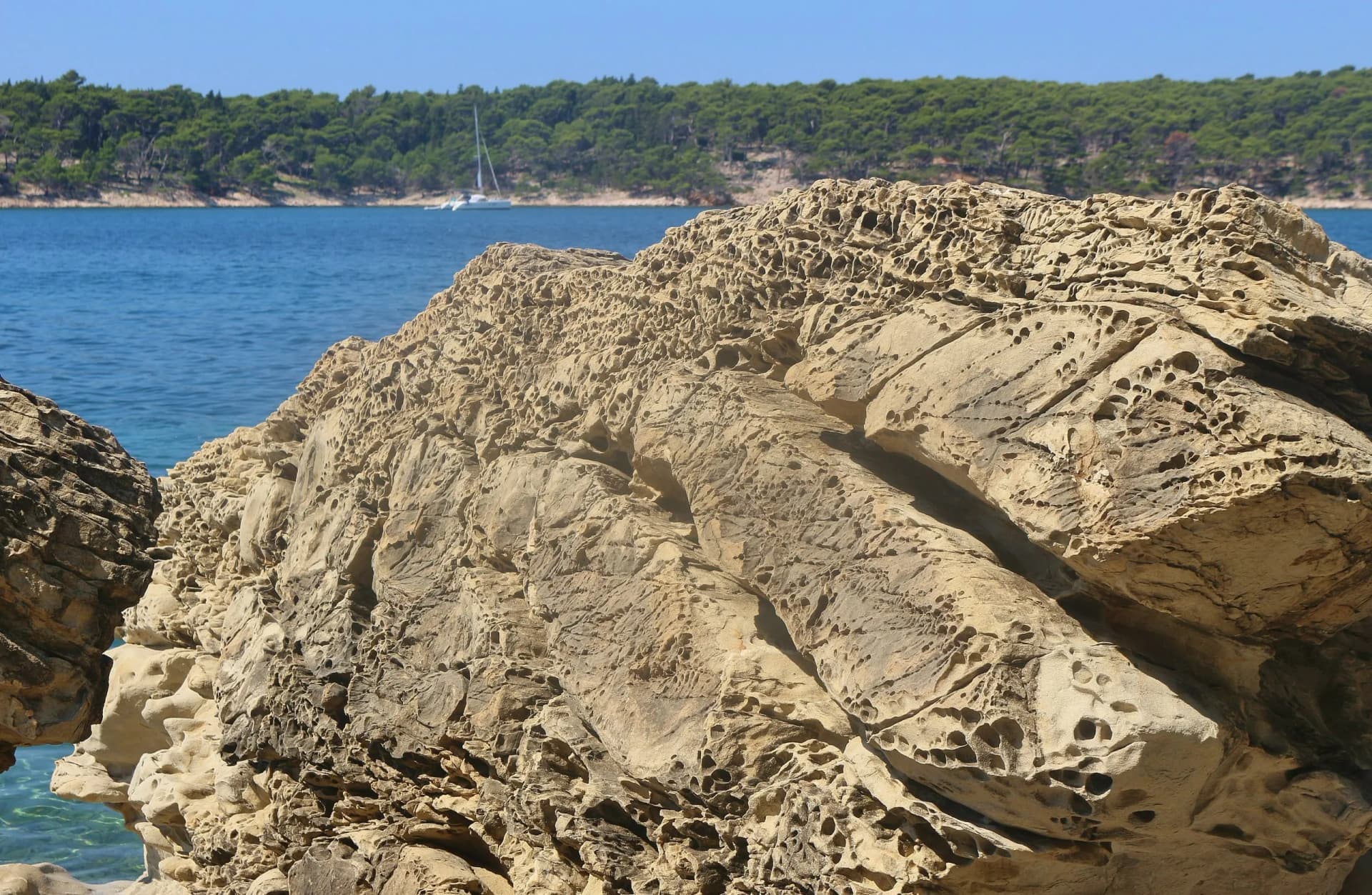 Bizarre sandstone rocks on the shore of the Adriatic Sea. In the old town of Rab island, view of the peninsula Kalifront. South-east Europe.