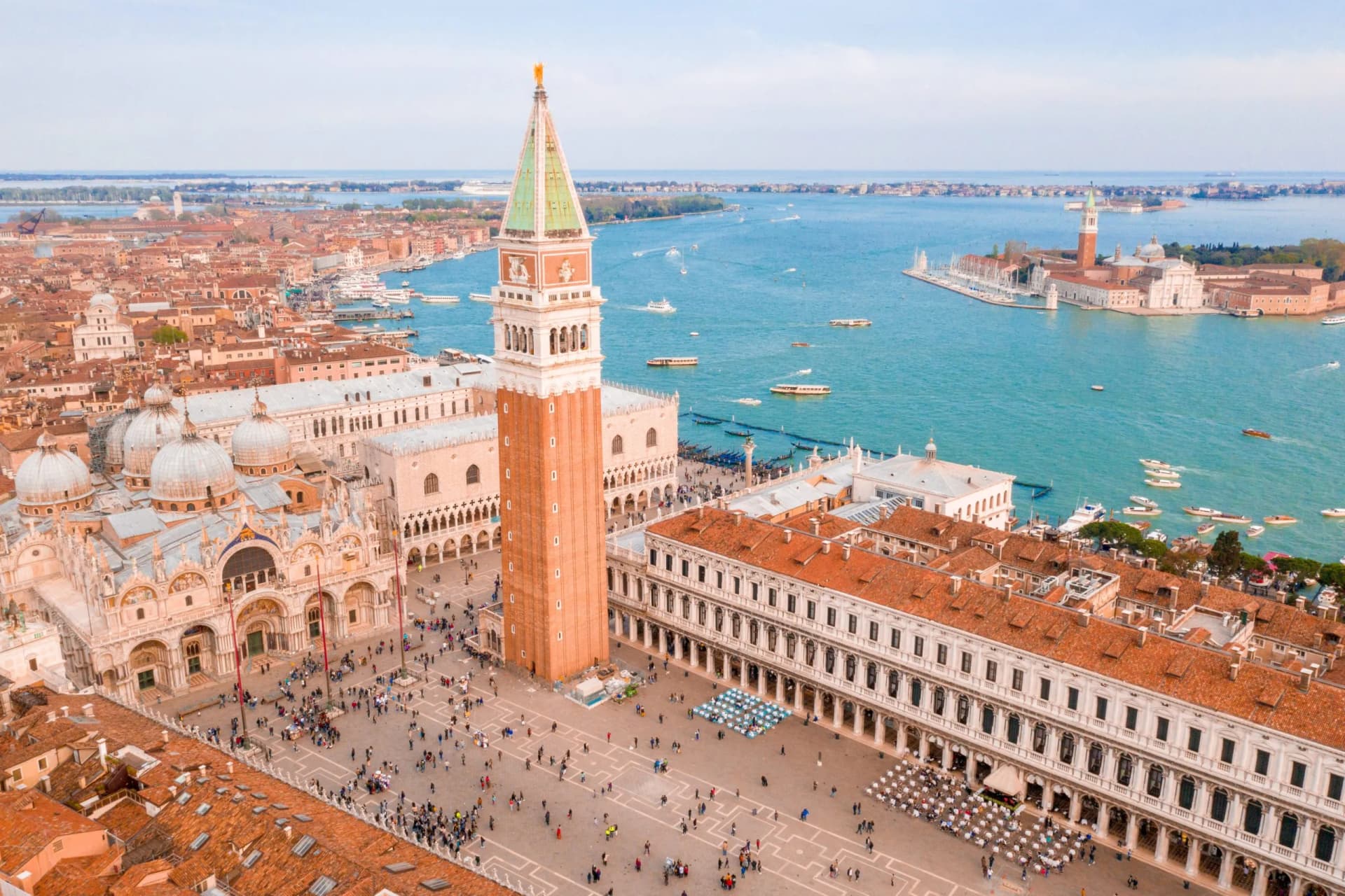 Aerial view of St. Mark's Square, Campanile, and Doge's Palace overlooking the lagoon in Venice.