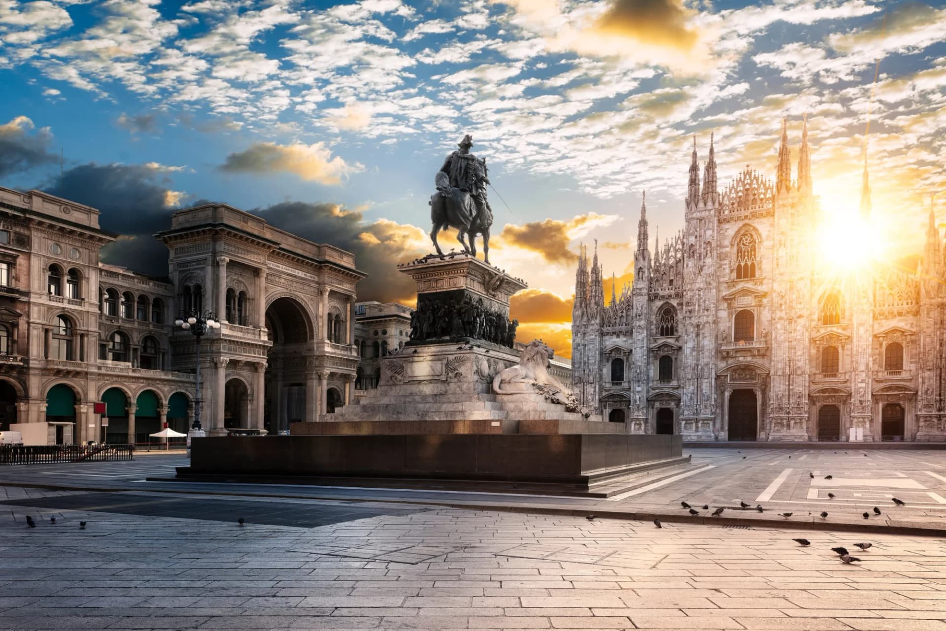 Piazza del Duomo with equestrian statue and Milan Cathedral at sunset