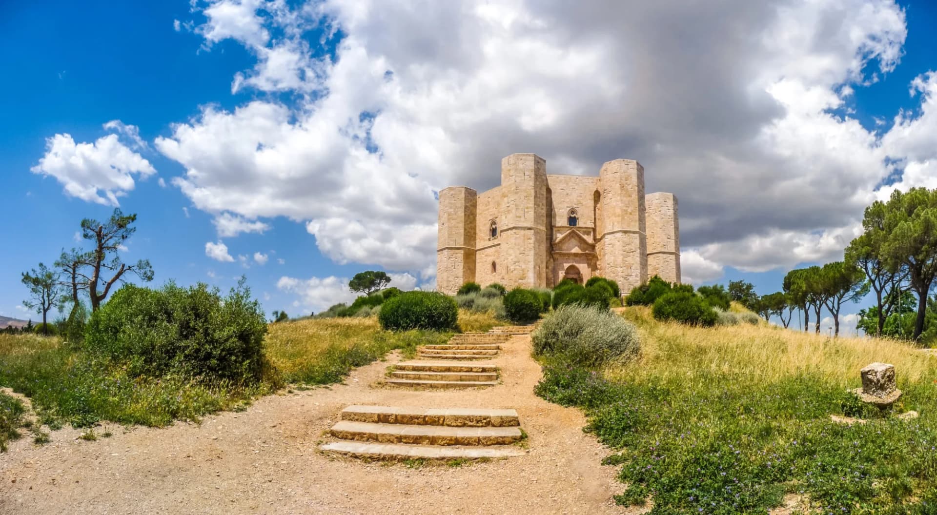 Castel del Monte 13th-century castle on a hill in Andria, Apulia, Italy, under a cloudy sky.