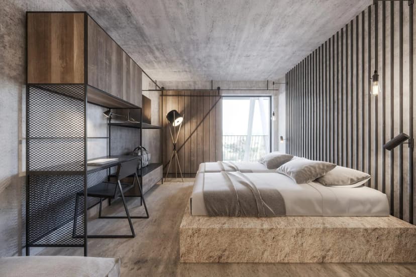 Modern hotel bedroom with twin beds on a raw wood platform and industrial shelving.