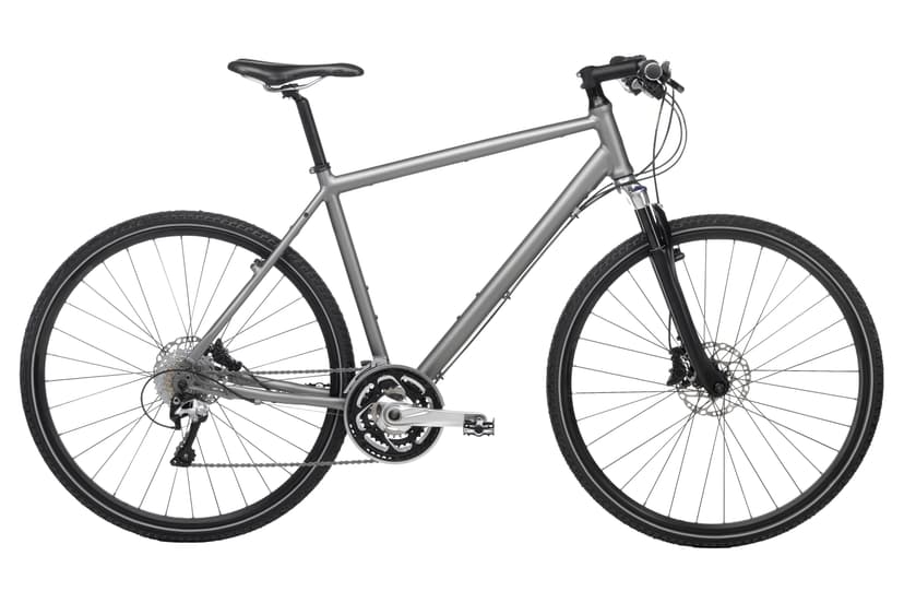 Silver trekking bike with disc brakes and knobby tires isolated on white background