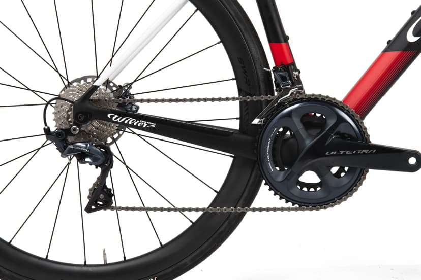 Close-up of Wilier road bike drivetrain with Shimano Ultegra components against white background.