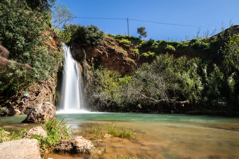 A waterfall in the heart of nature, a beautiful river and waterfall in spring. The Queda do Vigário waterfall near Alte, Algarve, Portugal