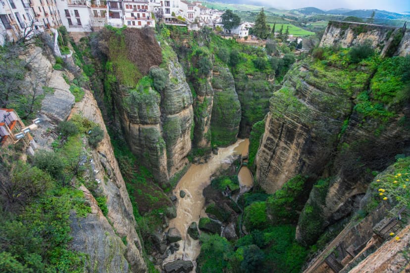 Dramatic view of Ronda a picturesque town in Andalusia Spain perched on cliffs overlooking the deep El Tajo gorge and the winding Guadalevin River