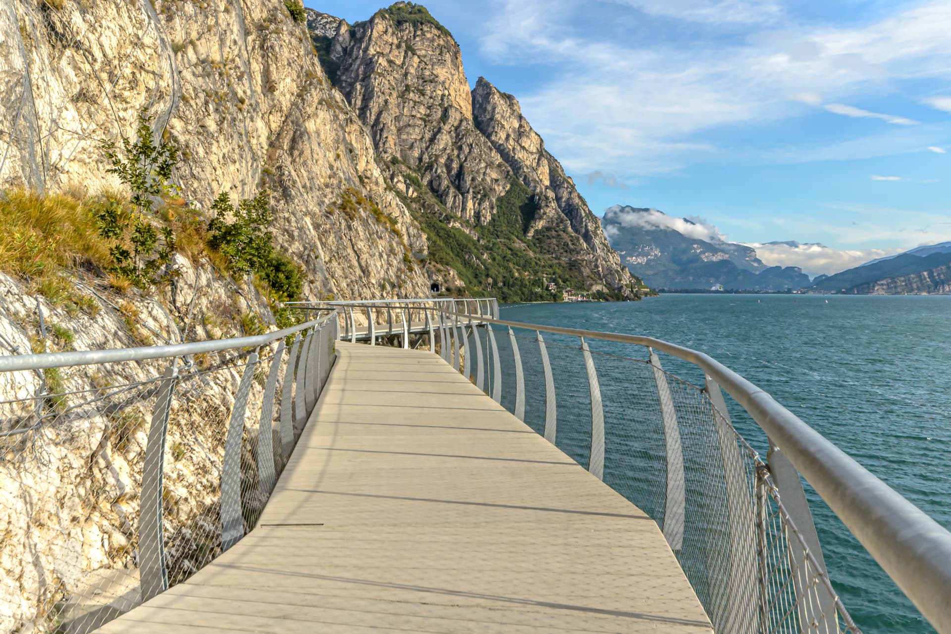 "Ciclopista del Garda" - Bicycle road and foot path over Garda lake with beautiful landscape scenery at Limone Sul Garda - travel destination in Brescia, Italy