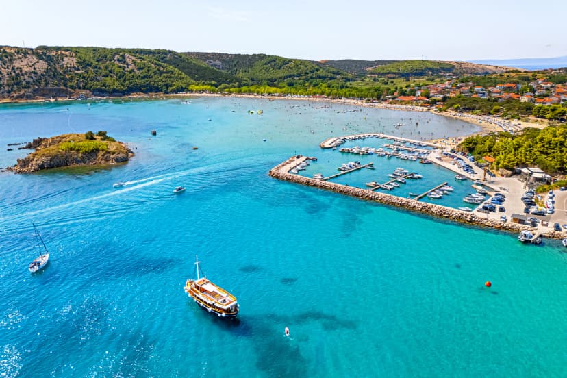 Croatia, sand beach on the island Rab view from drone. Adriatic Sea with turquoise water, marina near Lopar town