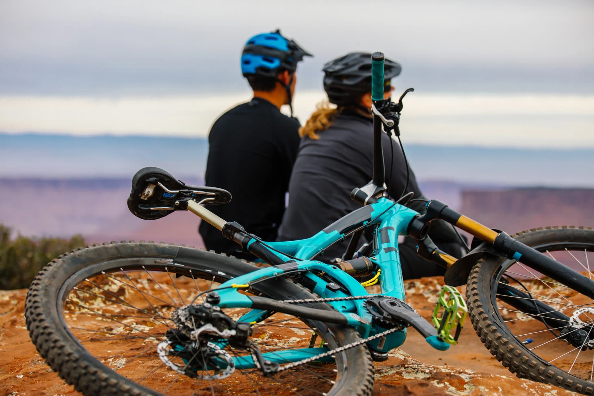 A Young Mountain Biking Couple Takes A Minute To Take In The Scenery